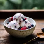 Cottage cheese ice cream recipe served with berries in natural light