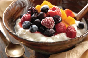 frozen fruit and yogurt breakfast bowl on rustic table
