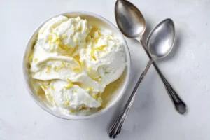 Jar of lemons cottage cheese ice cream in a rustic bowl