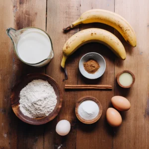 Ingredients for FODMAP banana pancakes dairy free laid out on wooden table