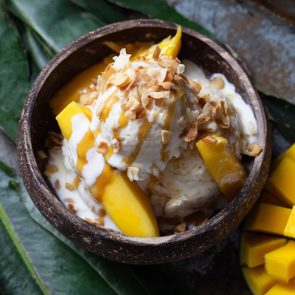 mango sticky rice ice cream served with mango slices and coconut