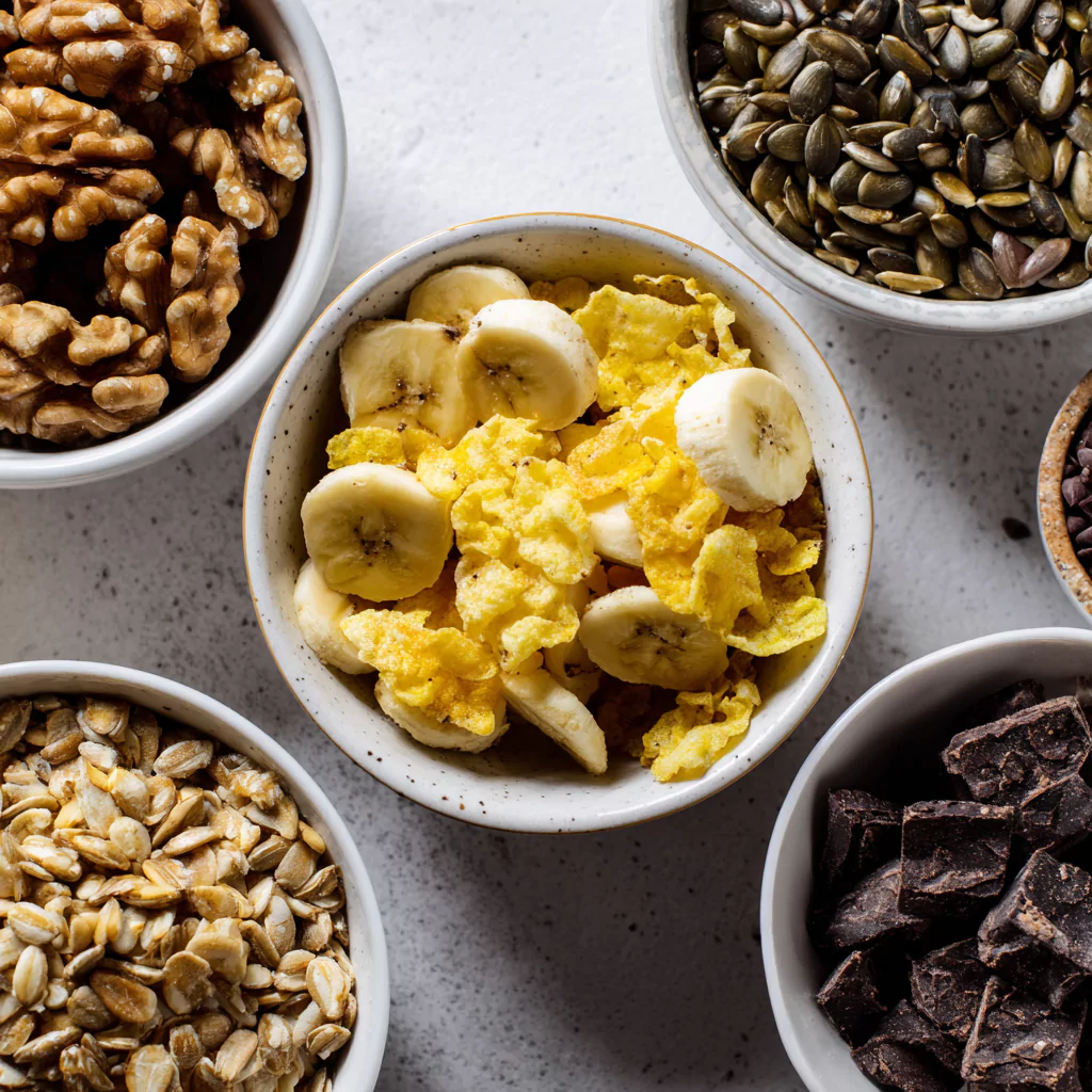 Close-up of labeled low FODMAP trail mix ingredients in separate bowls