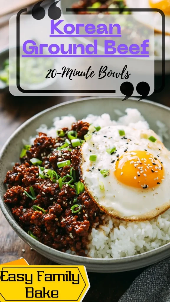 Side view of Korean ground beef bowl: beef over white rice with sunny-side egg, scallions and sesame in gray bowl.