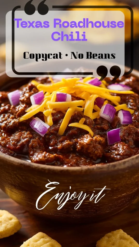 Texas Roadhouse chili, no beans, thick red sauce in a wooden bowl, topped with cheddar and red onion—copycat, chili Texas style.