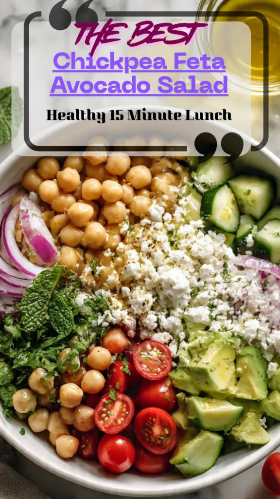 Overhead bowl of chickpea avocado feta salad with cucumber, tomato, red onion, and herbs; glossy lemon dressing; fresh Mediterranean lunch.