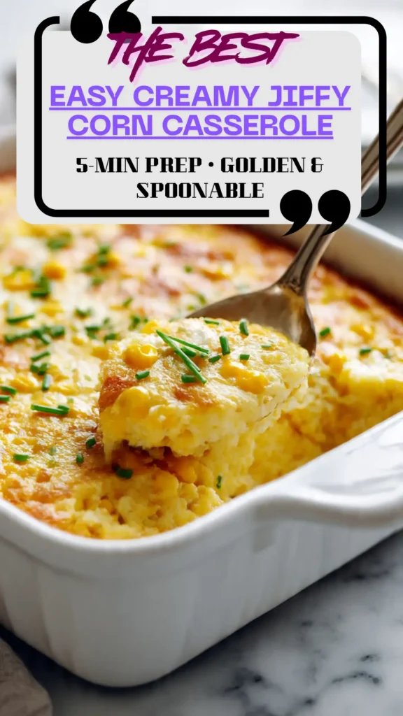 Golden Jiffy corn casserole in a white dish, creamy spoonable center with corn kernels; topped with chives; cozy side dish.