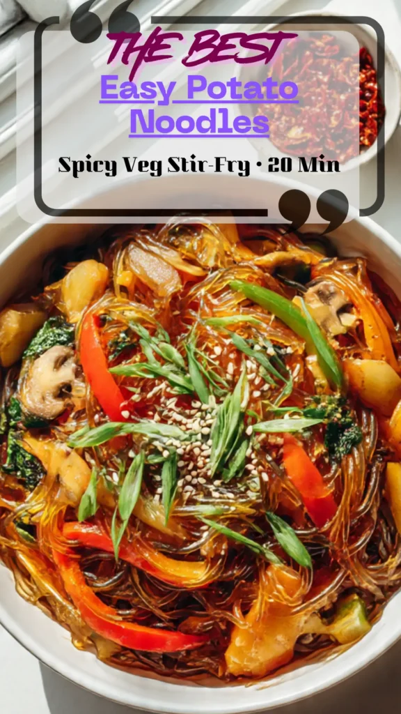 Top-down bowl of potato glass noodles with chili-garlic soy, colorful veg, scallions, and sesame seeds; glossy, spicy, 20-minute dinner.
