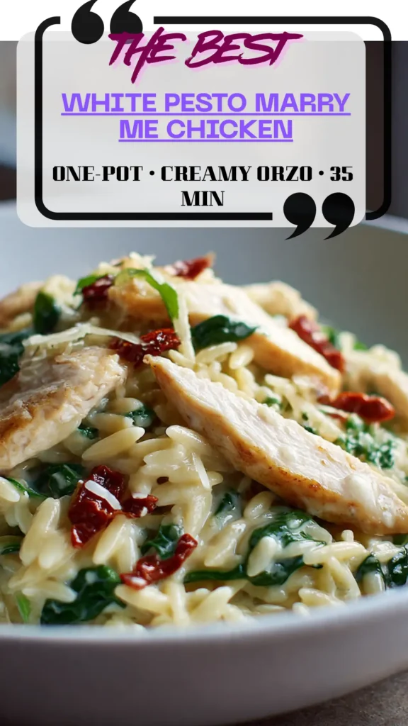 Side view bowl of creamy white-pesto orzo topped with seared chicken, spinach, sundried tomatoes, basil, and lemon; glossy sauce.