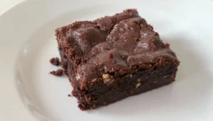 Delicious chocolate brownie dessert, rich and fudgy, served on a plate