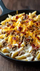 Bacon Cheeseburger Alfredo topped with crispy bacon and melted cheese