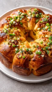 A beautifully decorated Boudin King Cake topped with colorful icing and festive sprinkles.
