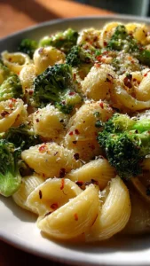 A bowl of easy healthy broccoli pasta with fresh vegetables and herbs.