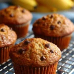 Freshly baked moist banana bread muffins on a cooling rack