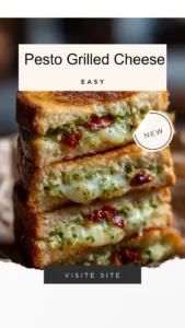 Pesto grilled cheese sandwich with melted cheese and fresh pesto on toasted bread.