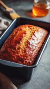A loaf of moist sourdough discard banana bread with slices cut