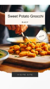 Plate of homemade sweet potato gnocchi topped with sauce and herbs
