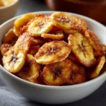Cinnamon-sugar air fryer banana chips in a bowl ready to be enjoyed.