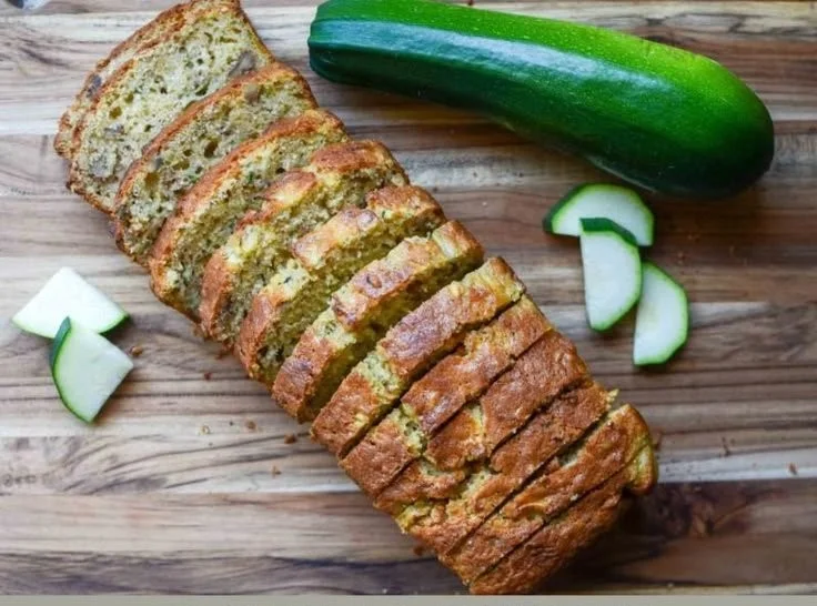 Loaf of homemade sourdough zucchini bread on a cutting board