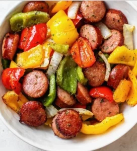 Air fryer sausage and peppers dish ready to serve, showcasing vibrant colors.