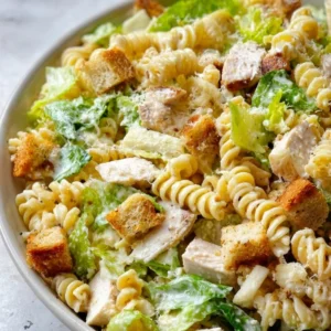 Chicken Caesar Pasta Salad with grilled chicken, romaine, pasta, and Caesar dressing