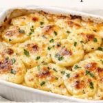 Baked creamy cheesy scalloped potatoes with golden cheese and layered potatoes