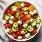 Fresh cucumber caprese salad with tomatoes and mozzarella