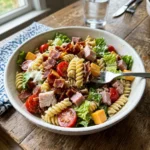A colorful bowl of Club Sandwich Pasta Salad with vibrant ingredients