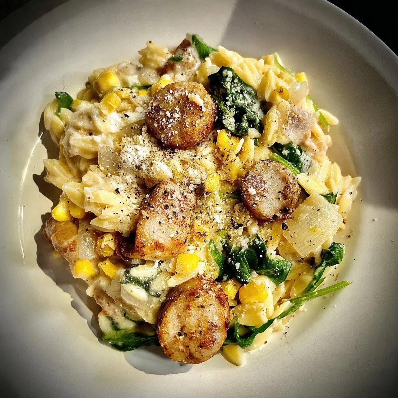 Creamy one-pot orzo with chicken sausage served in a bowl