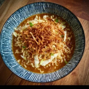 Bowl of French Onion Ramen garnished with crispy shallots
