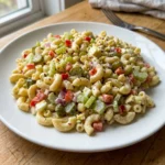 Gordon Ramsay's macaroni salad recipe with colorful vegetables and creamy dressing.
