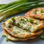 Homemade green onion cakes crispy and golden brown on a plate
