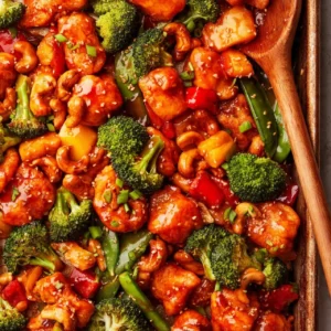 Sheet Pan Cashew Chicken with vibrant vegetables and nutty cashews on a baking tray.