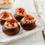 Smoked Gouda and bacon stuffed mushrooms on a serving platter