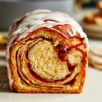 Loaf of Sourdough Discard Cinnamon Bread on a wooden cutting board