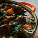 Hearty beef and sweet potato stew served in a rustic bowl