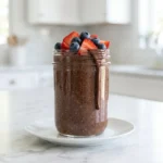 Delicious chocolate chia pudding topped with fresh berries in a bowl
