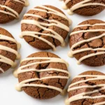 Coffee cookies drizzled with vanilla maple glaze on a white plate