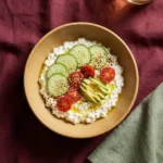 Cottage cheese bowl topped with fresh fruits and nuts for a healthy meal option.
