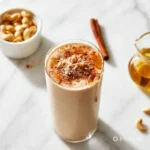 Delicious Goodie Maple Nut Shake in a glass with nuts and maple syrup