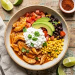 High-protein chicken enchilada bowl with cottage cheese, garnished with fresh toppings.