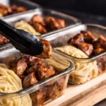 Creamy Honey Butter Chicken Alfredo served in a bowl with garnishes.