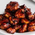 Keto Bourbon Chicken Thighs served on a plate with garnishes.