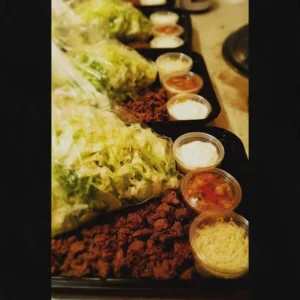 Meal prep for taco lunch with fresh ingredients and colorful toppings
