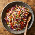 Bowl of vinegar coleslaw with colorful cabbage and carrots