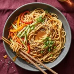 Delicious cold sesame noodle bowls topped with fresh vegetables
