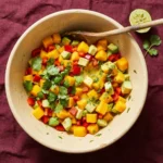 Fresh mango avocado salsa with lime served in a bowl