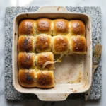 Plate of Ham and Havarti Cheese Sliders garnished with herbs.