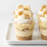 Delicious no-bake banana pudding cheesecake cups garnished with banana slices.