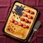 Delicious Patriotic Sheet Pan Pancake topped with fresh berries and whipped cream