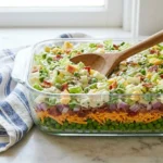 A colorful Seven Layer Salad showcasing freshness and vibrant ingredients in layers.